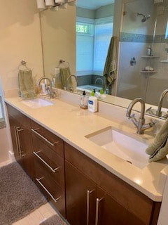 Picture of a beautifully clean, organized, uncluttered bathroom vanity, sink, and mirror.