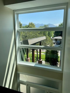 This is a picture of a window where the glass is so perfectly can and streak-free you see through the window to the deck beyond as if there were no glass there at all.